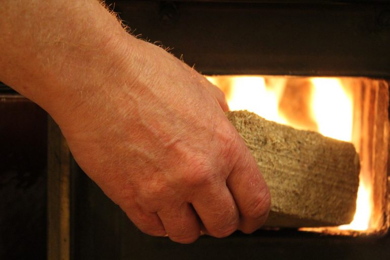 Placing wood briquettes on a fire